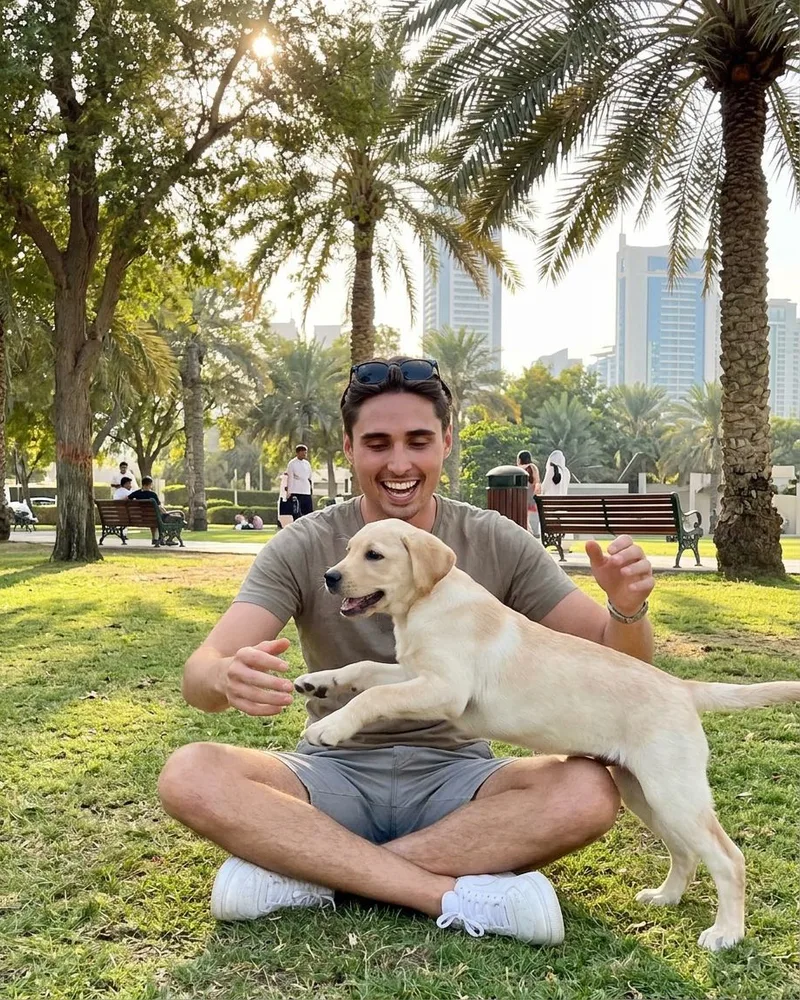 Man spending time outdoors with a small dog